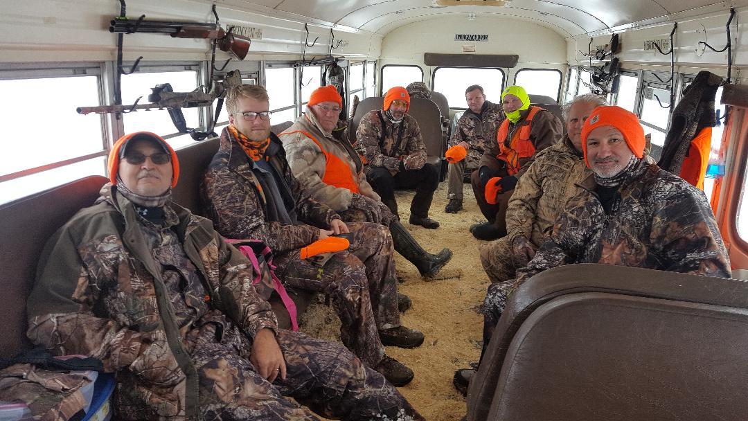 a group of men wearing camouflage sitting in a bus