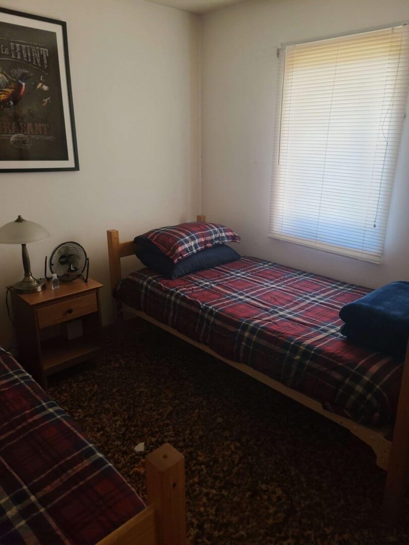 a bed with plaid sheets