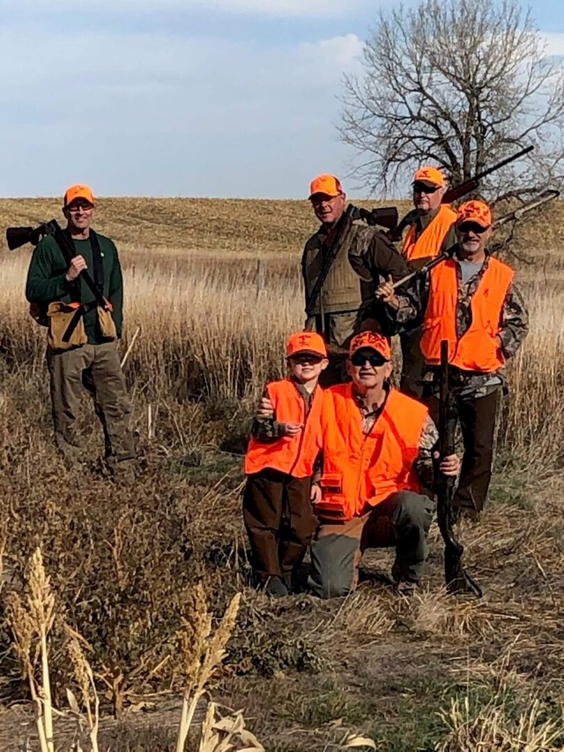 a group of men and a boy standing in a field