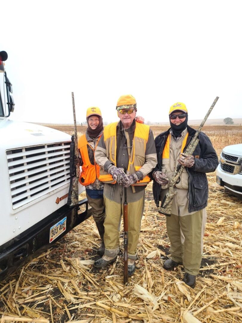 three men in wearing hunting gear