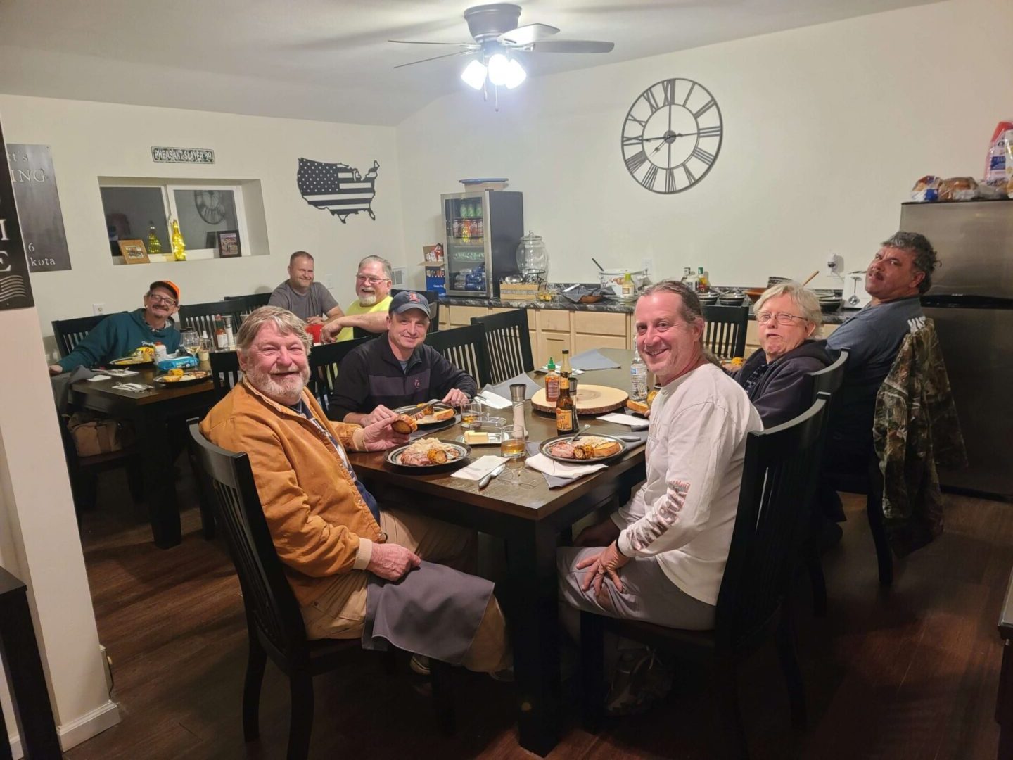 a group of men sitting and eating at tables