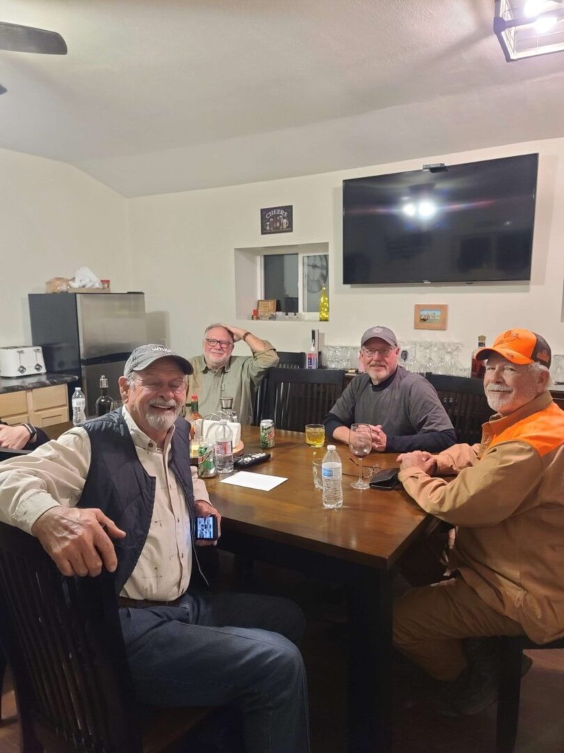 four men sitting at a table