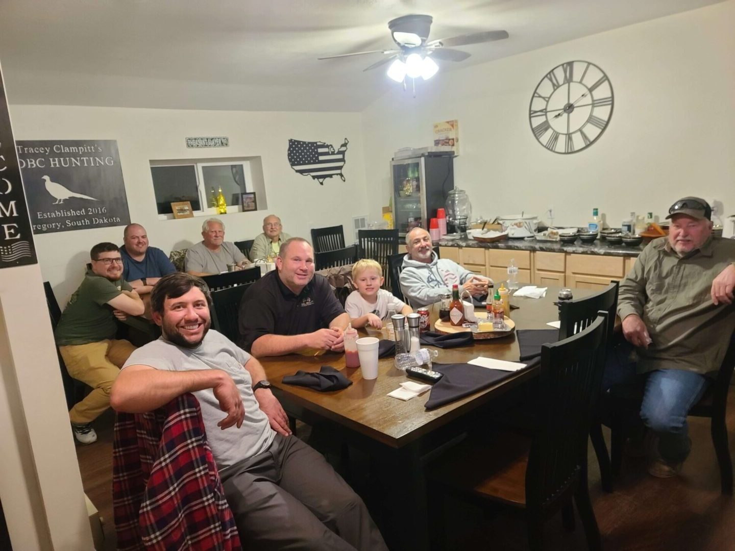 a group of smiling people sitting at tables