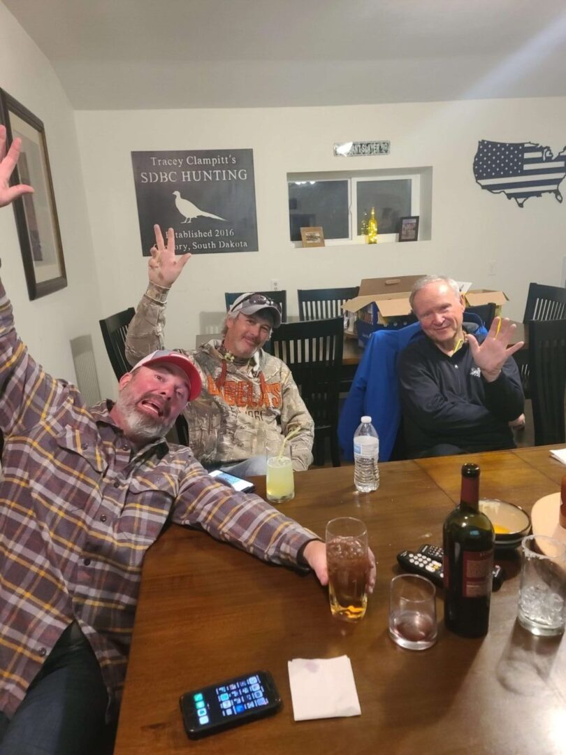 three men drinking at a table