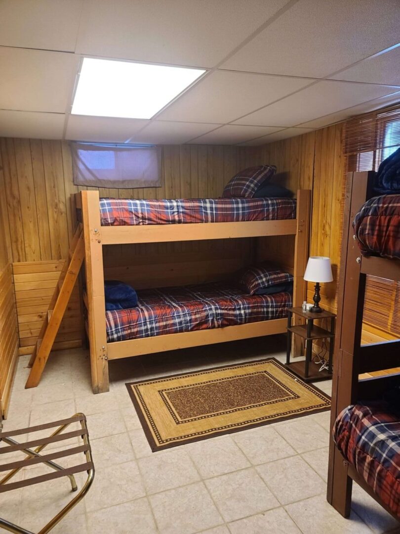 a bunk bed with plaid sheets