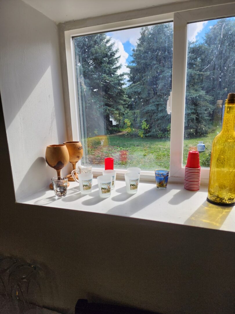 Tea Cups and Bottle on the Window Table