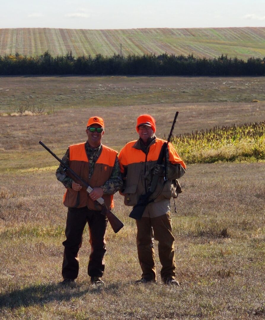 Two Hunters with Gun on The Field