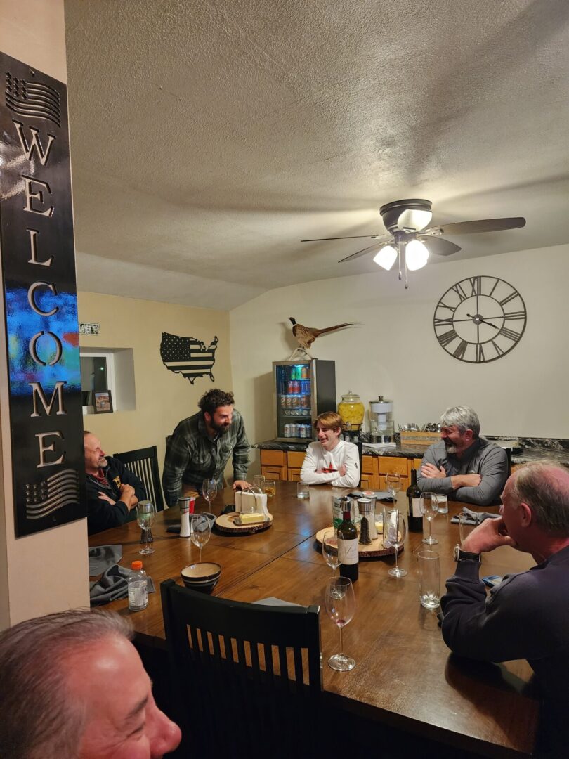 Hunting Team Having a Wine at Dining Table