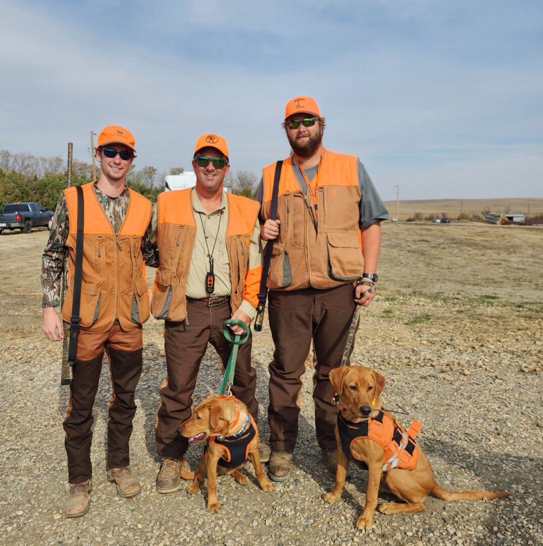 Hunters With Dogs on The Field