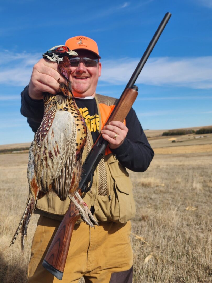 Hunter Man Holding a Bird and Gun