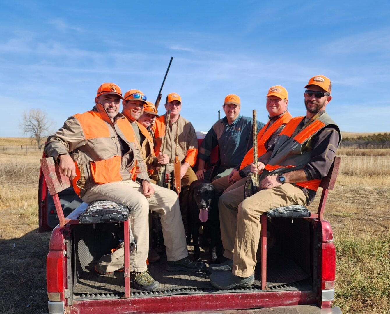 Group of Hunting Team Sitting on the Truck