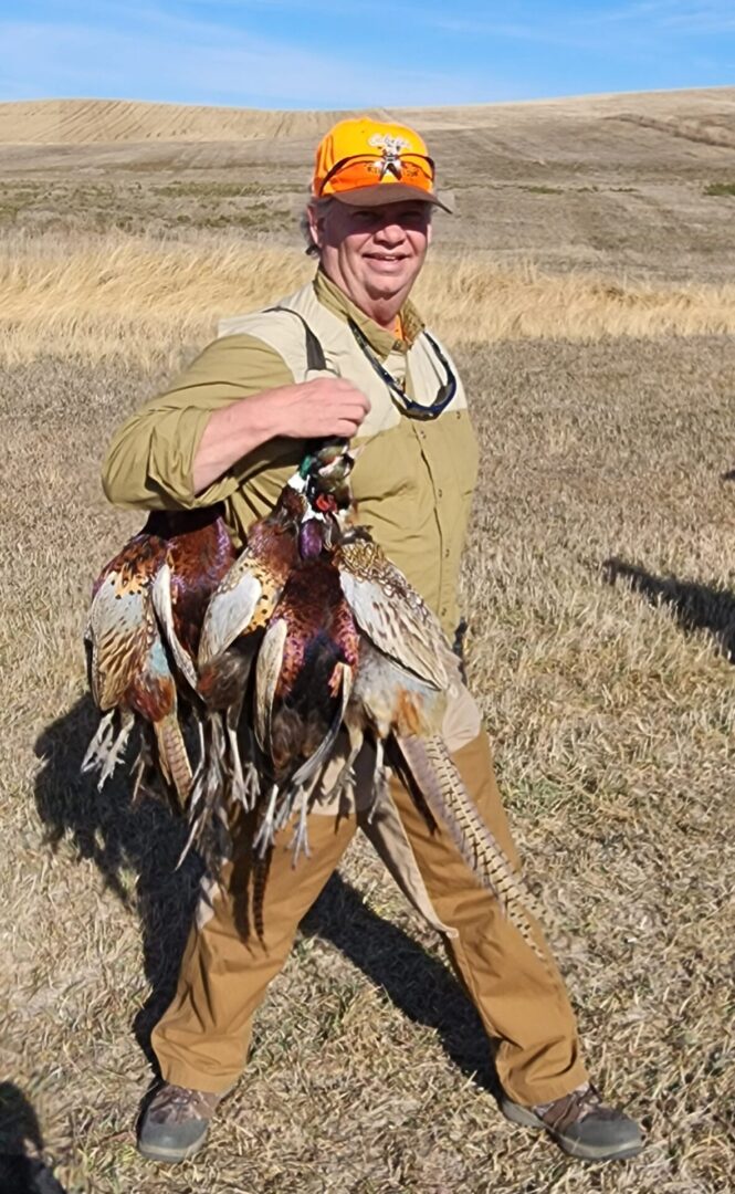 Hunter Man Holding a Birds at Field