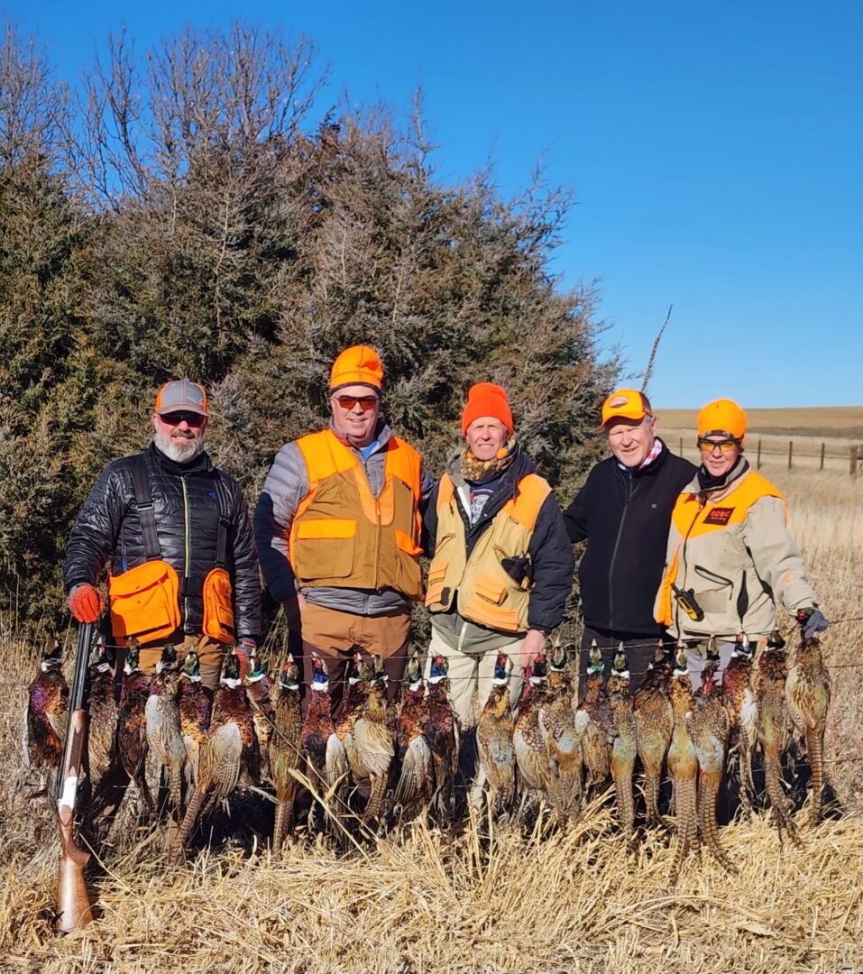 a group of five people with birds