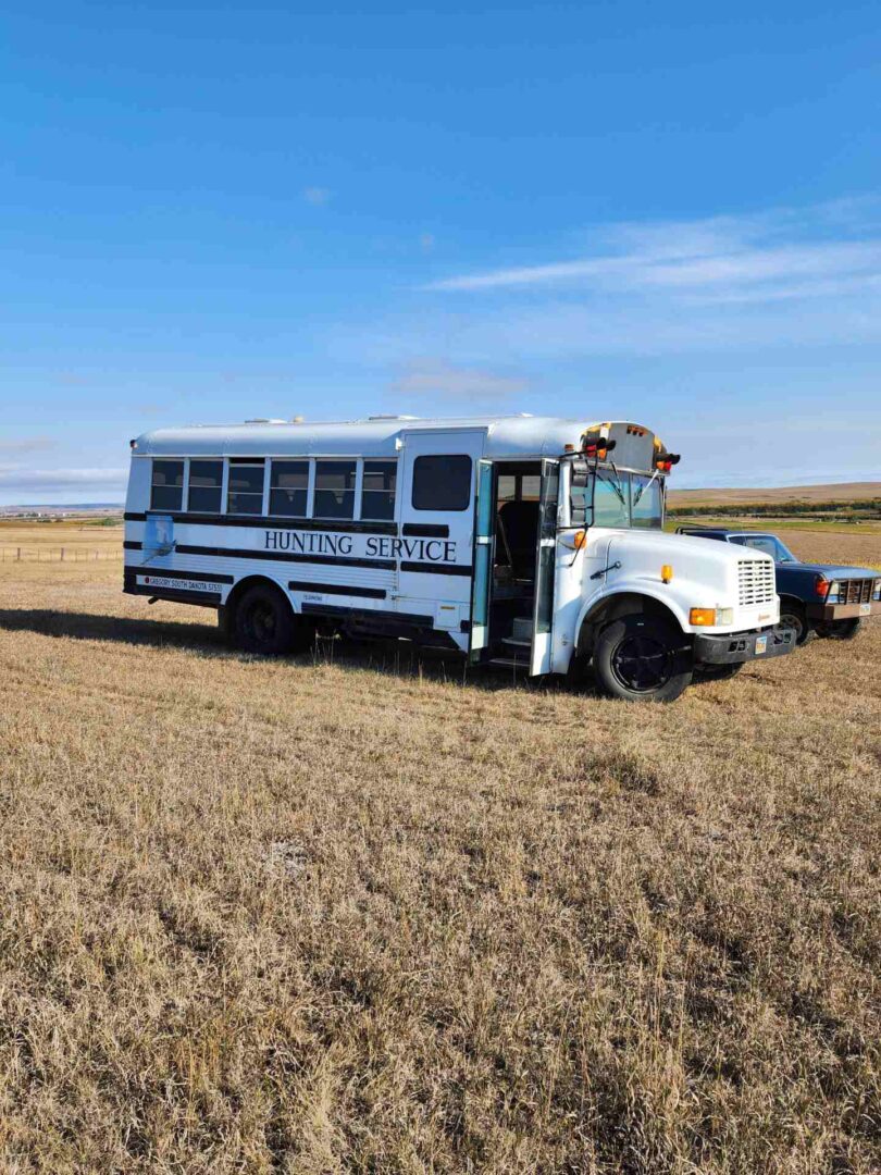 a Hunting Service Van and a car on the ground